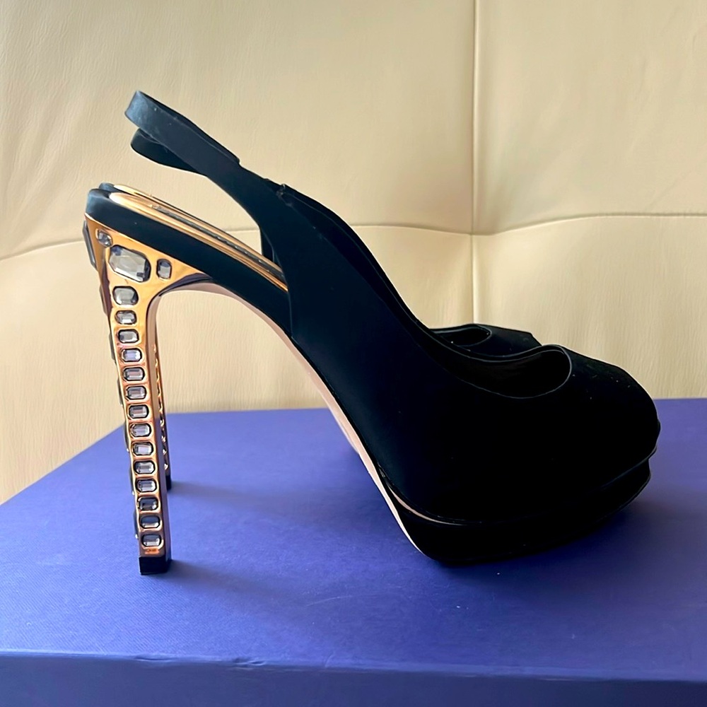 BCBG Ramsey pump with a gold heel and stones Has been worn but in good condition